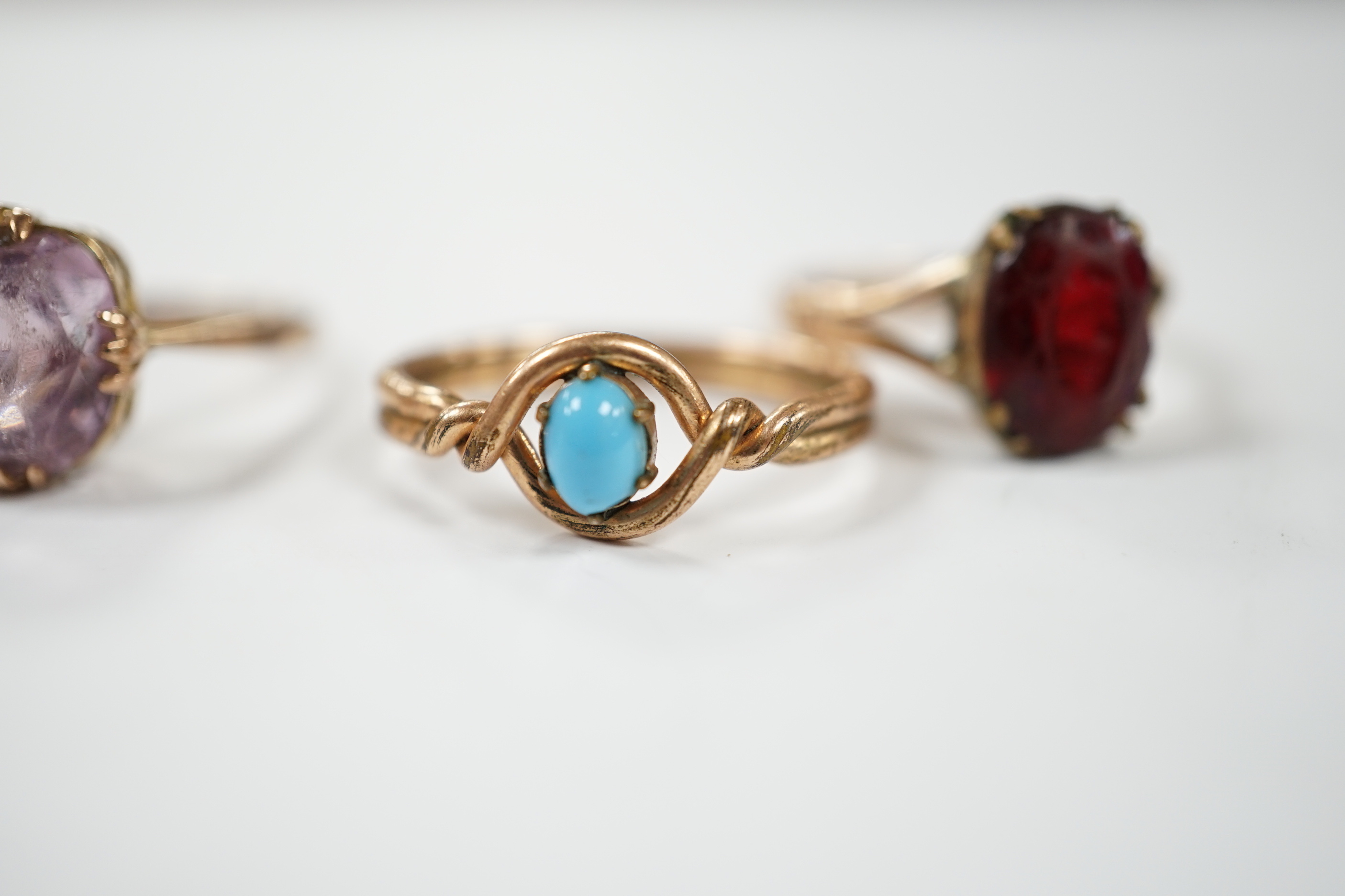 Two yellow metal and gem set rings, one stamped 9ct, gross weight 7.7 grams and two other rings.